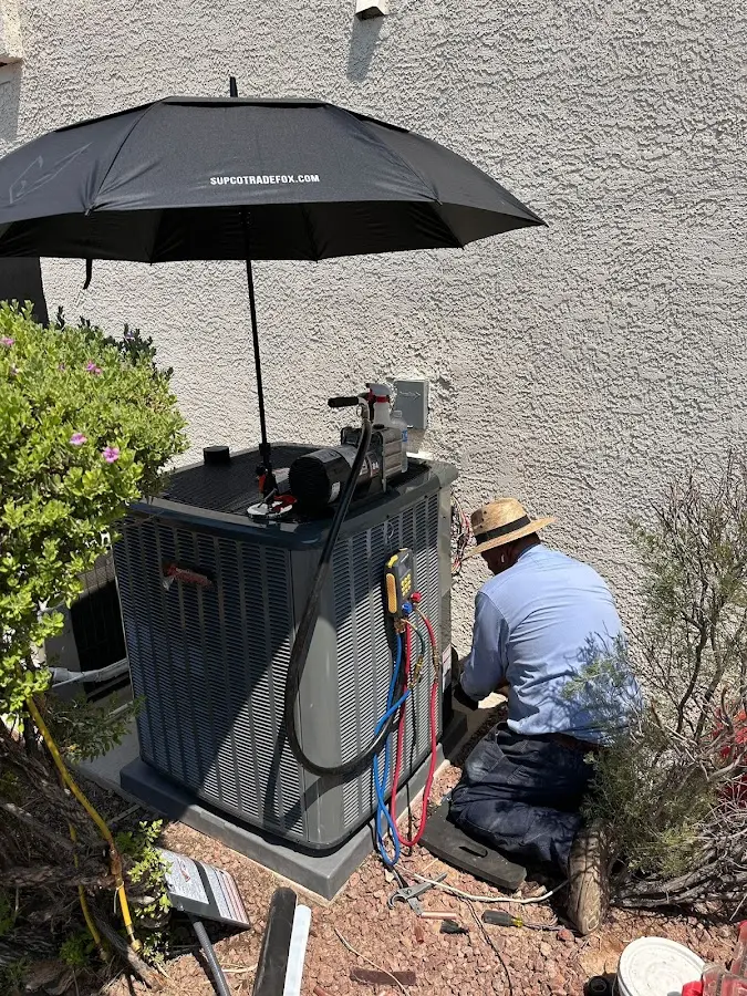 HVAC technician performing outdoor AC maintenance in Paradise Valley